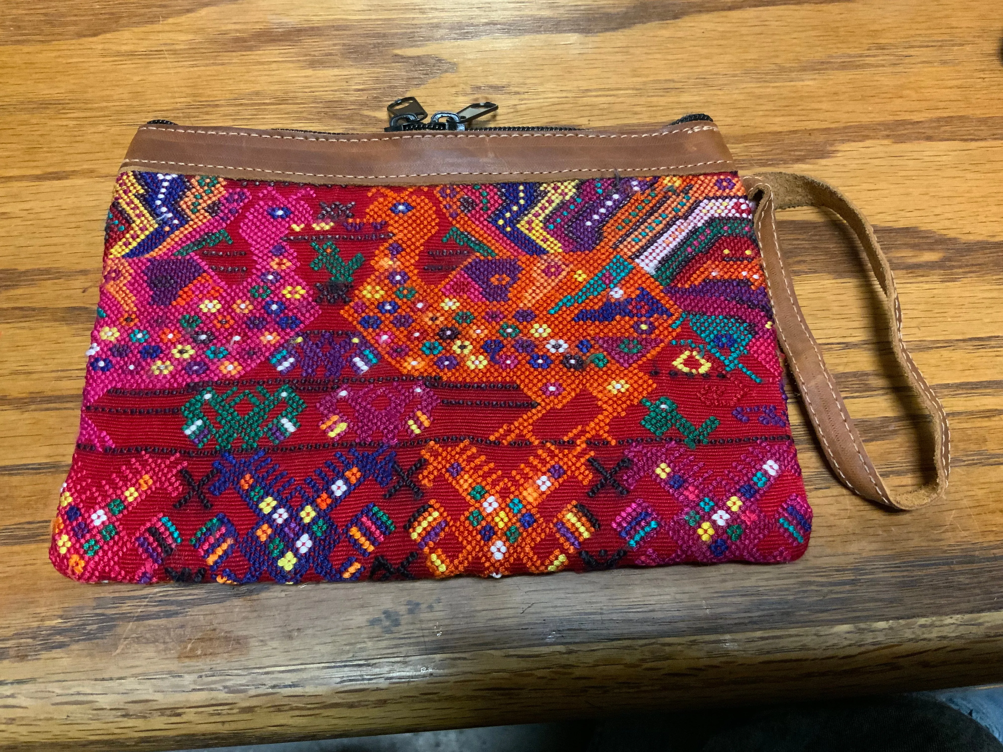 Handwoven vintage fabric wristlet bag with leather. 9” x 6”.