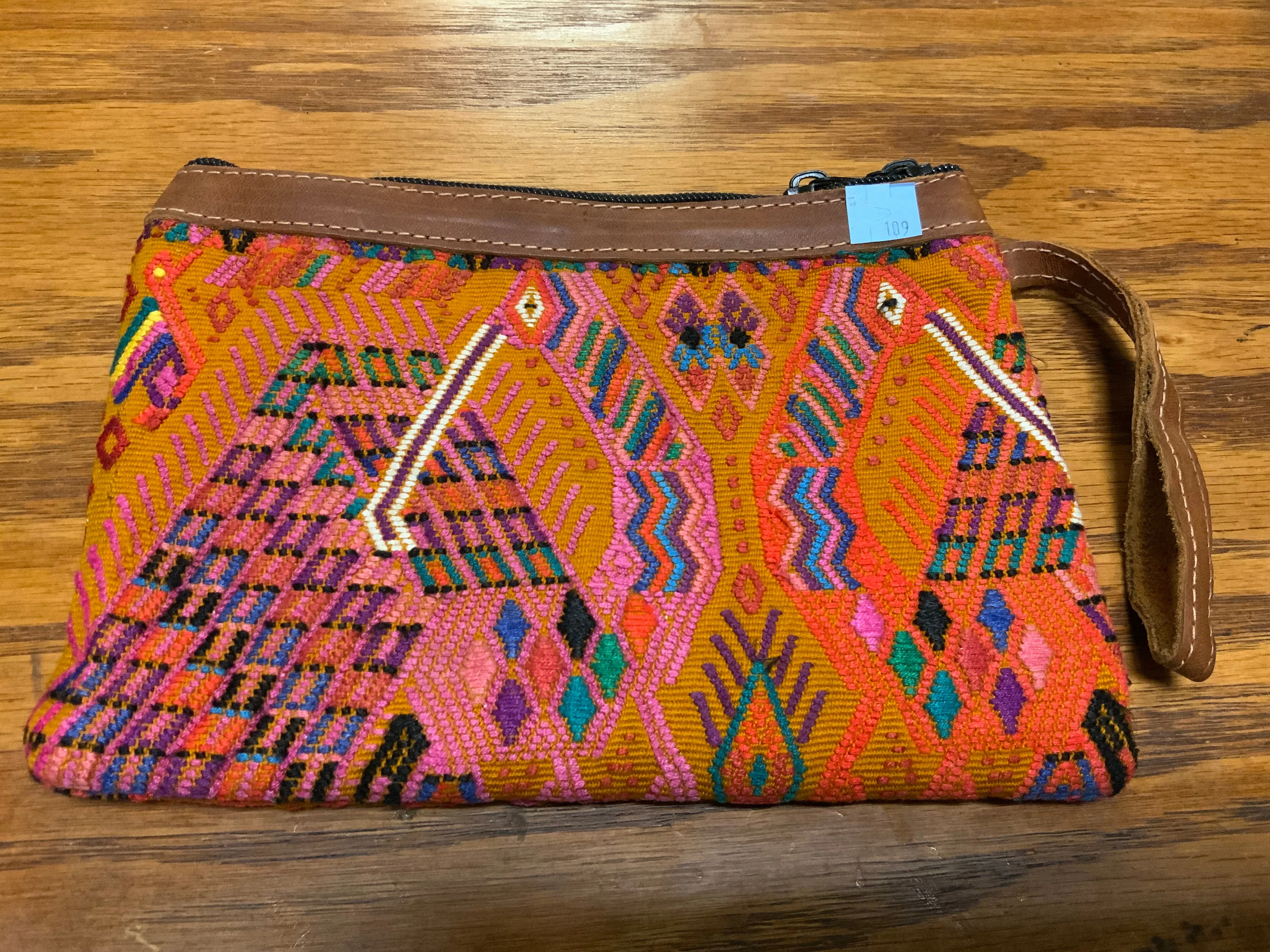 Handwoven vintage fabric wristlet bag with leather. 9” x 6”.